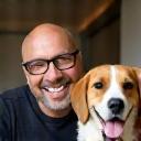 Jamil smiling with his friendly beagle Milo