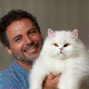 Marvin holding his Persian cat Misty after grooming